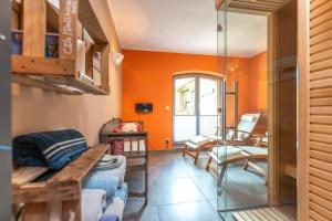 a living room with an orange wall at Das Backsteinhus, App Achterland in Dargen