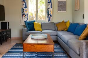 a living room with a couch and a coffee table at La Maison Bleue in Rustrel