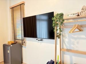 a flat screen tv hanging on a wall at Pomt Lagoon in Ban Khlong Dan