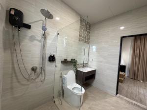 a bathroom with a shower and a toilet and a sink at Pomt Lagoon in Ban Khlong Dan +9 photos