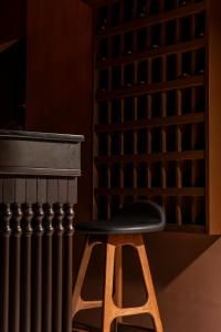 a black stool sitting next to a radiator at Merchant's Gate Songwat in Bangkok