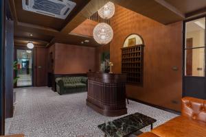a living room with a couch and a table at Merchant's Gate Songwat in Bangkok