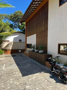 a motorcycle parked in front of a house at Studio-type apartment in Praia do Forte in Mata de Sao Joao