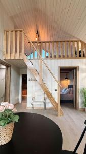 a living room with a staircase and a bed at Rūdupji Anna in Kalniena