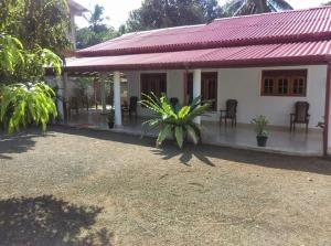 a house with a red roof at Luckwin Guest in Anuradhapura
