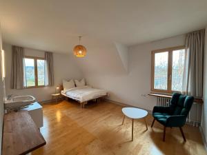 a living room with a bed and a table at berg zeit in Hinterzarten in Hinterzarten