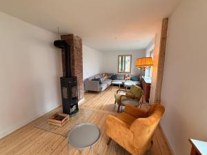 a living room with a wood stove and a couch at berg zeit in Hinterzarten in Hinterzarten