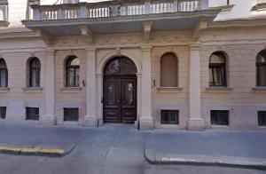 a building with a brown door with a balcony at Budapest Holidays Storia in Budapest