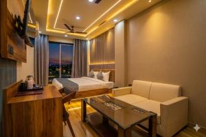 a hotel room with a bed and a table at Hotel De Grand Dwarka-Near Jaipur Airport in Jaipur