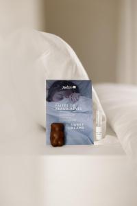 a box of cake bar sitting on top of a bed at Radisson Blu Hotel, Rouen Centre in Rouen +116 photos