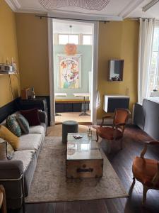 a living room with a couch and a table at Appartement centre rennes in Rennes