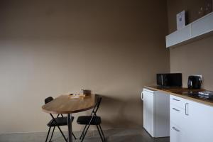 a small kitchen with a wooden table and chairs at Blue Viking Studios in Keflavík