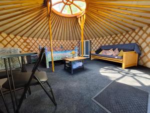 a room with a yurt with a bed and a table at Sheviock Barton Yurt in Sheviock