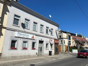 a white building on the corner of a street at Pension Lizzi in Vienna