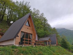 a cabin with a gambrel roof on a hill at Vikendice Limski mir in Andrijevica