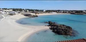 an aerial view of a beach with rocks in the water at By Domy 2 Grottaglie in Grottaglie