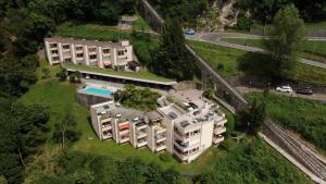 an aerial view of a building with a swimming pool at Bella-Lugano in Aldesago