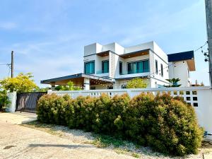 a house with a white fence at Bonus Pool Villa Chiang Mai in Chiang Mai