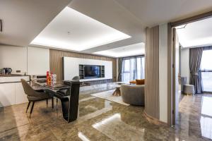 a living room with a dining table and a couch at HK Hotel Bangkok in Ban Bang Toei (1)