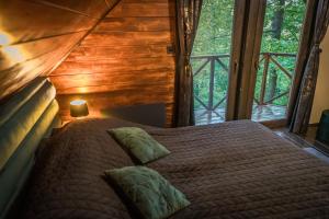 a bedroom with a bed in a tree house at Mátra Boutique in Mátraszentimre