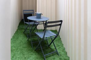 two chairs and a table with a cup on top at Love Room avec Jacuzzi - Le cocon caché in Bressuire