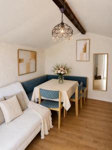 a living room with a table and a couch at Maisonnette avec piscine - sud Ardèche in Saint-Montan