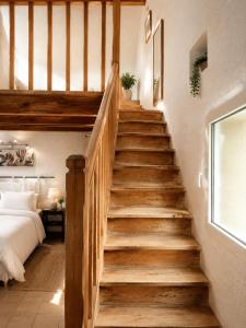 a staircase leading up to a bedroom with a bed at Maisonnette avec piscine - sud Ardèche in Saint-Montan