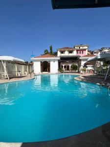 a large swimming pool in front of a house at TULIVU Homes in Mombasa