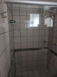 a shower with a glass door in a bathroom at Flat Di Roma 110A Rio Quente in Rio Quente +9 photos
