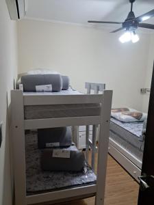 a room with two bunk beds and a ceiling fan at Departamento juana con cochera in Rafaela