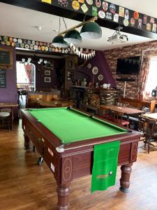 a pool table in the middle of a pub at The Cross Keys in Worthington