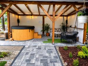 a patio with a gazebo and a bench at Biały Domek Świerczek - Jacuzzi, Balia Ruska SPA, Rowery, Altana i Grill w Słopnice in Słopnice