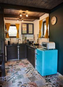 a kitchen with a blue refrigerator and a microwave at Mátra Boutique in Mátraszentimre +9 photos
