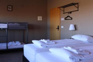 two beds in a room with white towels on them at Blue Viking Studios in Keflavík