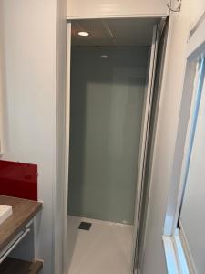 a glass door to a shower in a bathroom at Mobil-home val de durance in Cadenet +10 photos