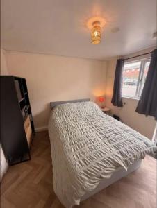 a bedroom with a large bed and a window at The Burrow at Black Rabbit Pub in Haybridge