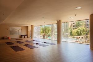 a large room with yoga mats on the floor at Luna Park Hotel Yoga & Spa in Malgrat de Mar