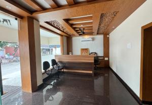 an office with a desk and chairs in a room at Nandha Grande Elite in Udumalaippettai
