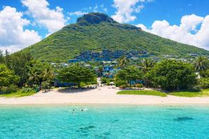 a view of a beach in front of a mountain at Manta Cove by Blue Zebra Holidays in Rivière Noire
