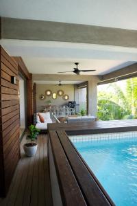 a house with a swimming pool and a living room at Manta Cove by Blue Zebra Holidays in Rivière Noire