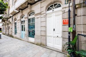 a white door on the side of a building at YBH Mare Boutique in Vigo +88 photos