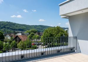 a balcony with a view of a city at stay flex Hotel & Apartment in Hertenstein