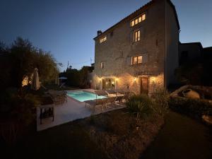 a building with a swimming pool in front of it at Bastide de Peyloubet in Grasse