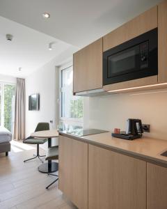 a kitchen with a counter and a table with chairs at stay flex Hotel & Apartment in Hertenstein