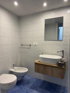 a bathroom with a tub and a toilet and a sink at Fefalù House in Ischia Town