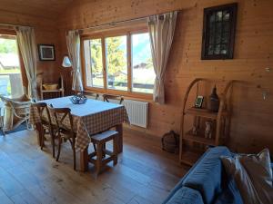 a dining room with a table and a couch at Chalet AS des Pics in Nendaz