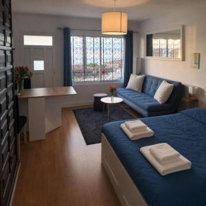 a living room with a blue bed and a couch at Oceanview Mesa del Mar in Santa Cruz de Tenerife +15 photos