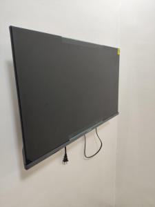 a flat screen tv hanging on a wall at Negradas Transient Inn-with Air-conditioning in Manolo Fortich