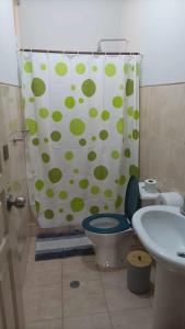 a bathroom with a toilet and a shower curtain at Gira Lua in Igreja