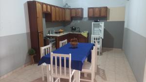 a kitchen with a table with a blue table cloth at Gira Lua in Igreja